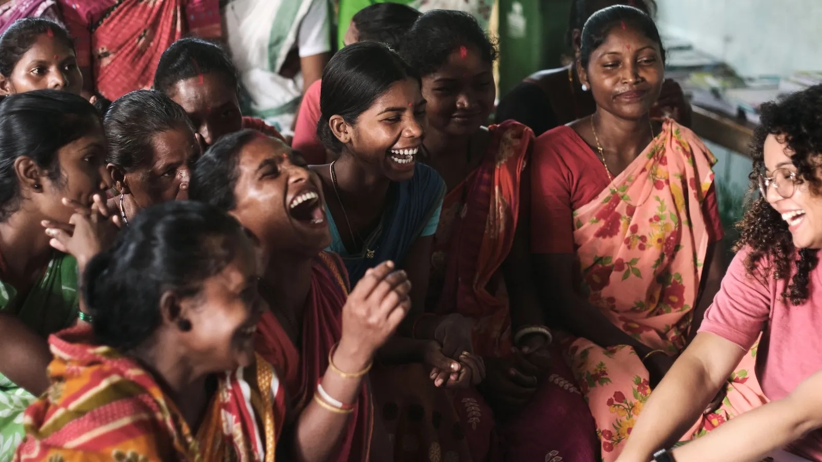 A group of Indian women laughing.