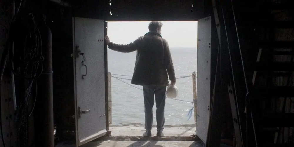 Paul White facing sea with back towards camera