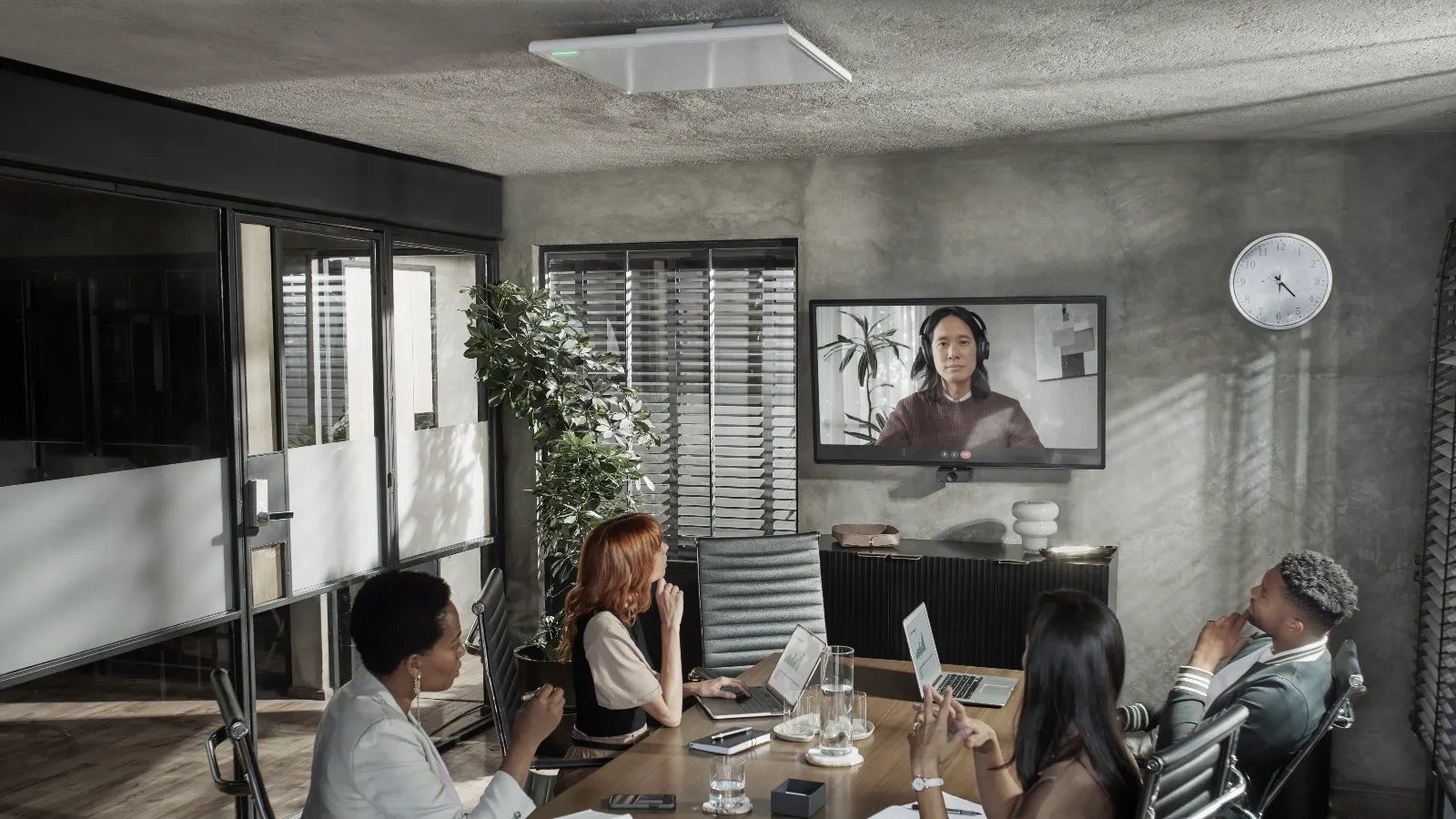 Group of people videoconferencing in a meeting room